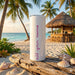 Tumbler with 'Ask your name' text on a beach setting with palm trees and a hut.