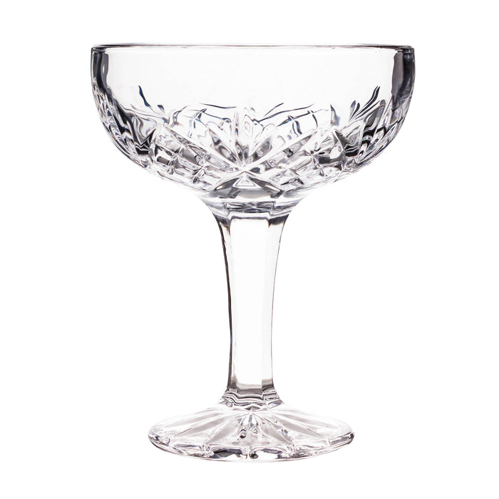 Clear glass coupe with intricate cut design on a white background