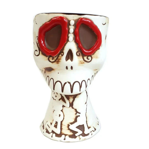 Ceramic skull mug with red eyes on a white background