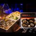Frescolive olive packaging with olives and lemons on a bar counter
