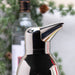 Penguin-shaped cocktail shaker with a blurred background