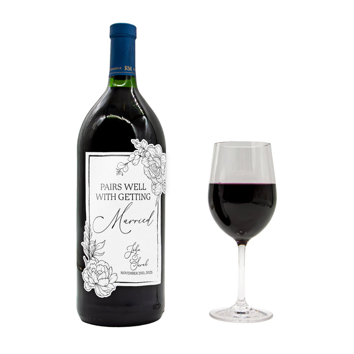 Wine bottle with a decorative label and a glass of red wine on a white background
