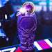 Purple cocktail in a warrior-themed glass with garnishes on a blurred bar background
