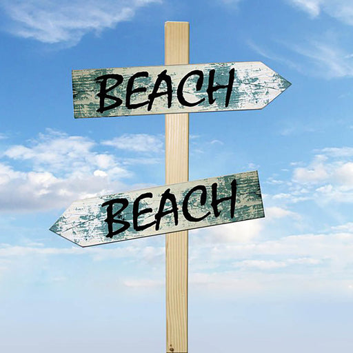 Wooden signpost with 'BEACH' signs pointing in different directions against a blue sky.