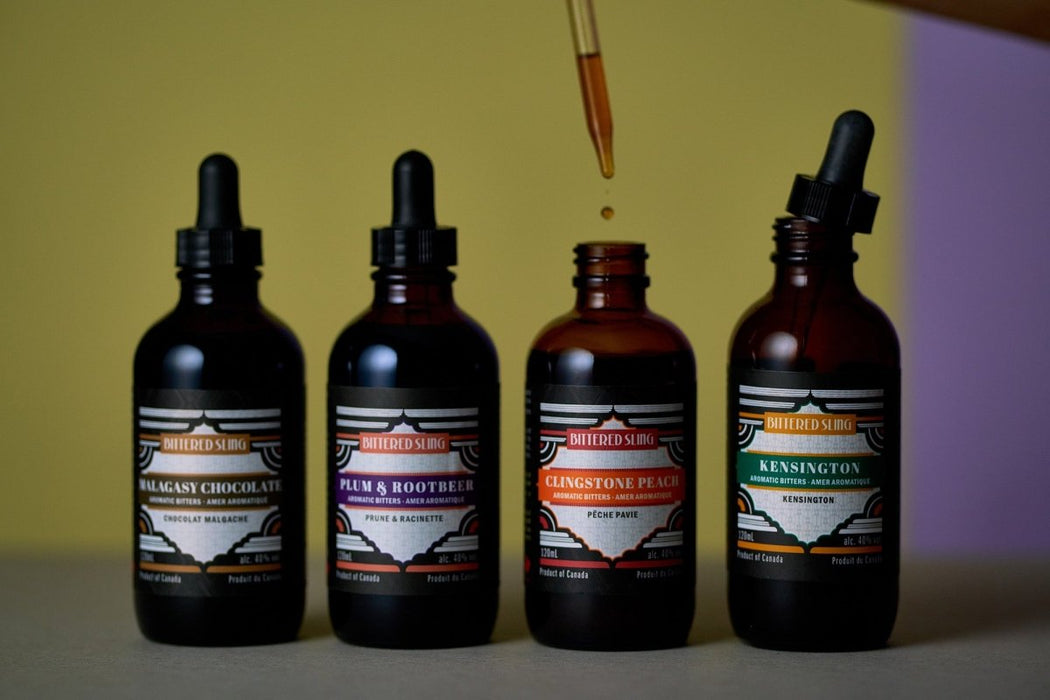 Four bottles of different flavors with dropper bottles on a gradient background