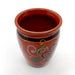 Ceramic cup with decorative patterns on a white background