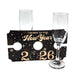Two champagne flutes with a 'Cheers to the New Year 2026' holder on a white background