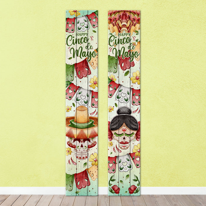 Decorative door panels with Cinco de Mayo theme on a yellow wall.