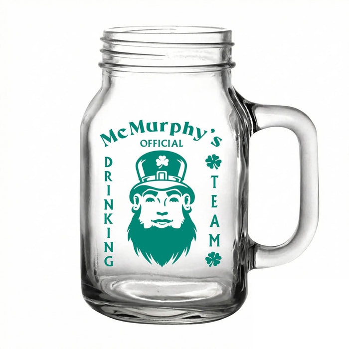 Clear glass mug with green text and a graphic of a leprechaun on a white background