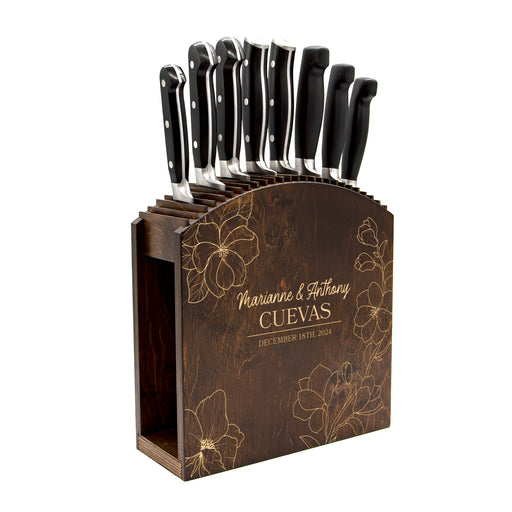 Set of knives in a wooden block with engraved names and dates on a white background