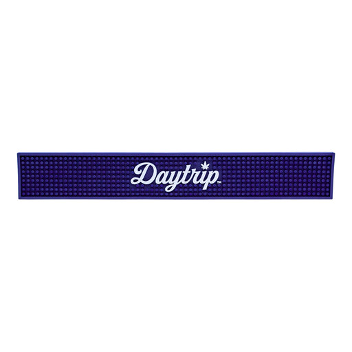 Blue bar mat with 'Daytrip' logo on a white background