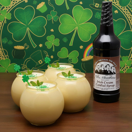 Bottle of Irish Cream Cordial Syrup with creamy drinks and shamrock decorations on a St. Patrick's Day-themed background.