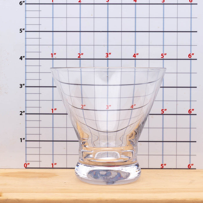 Clear glass with measurement grid on a wooden surface