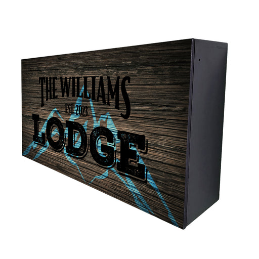 Wooden sign with 'The Williams Lodge' text on a white background