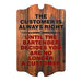 Wooden sign with humorous quote about customers and bartenders on a white background