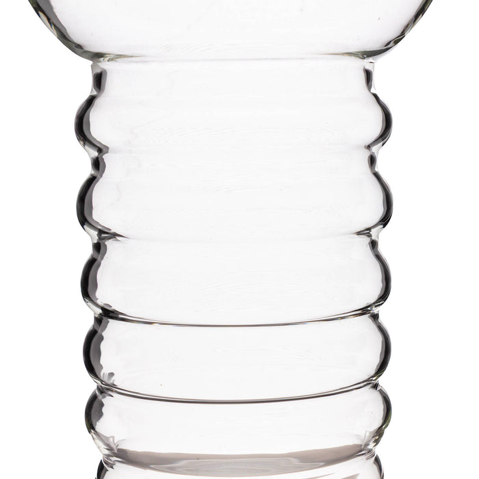 Clear glass vase with wavy design on a white background