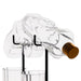 Clear glass bottle rack holding two clear glass bottles, with a gold-toned stopper visible on one bottle, set against a white background.