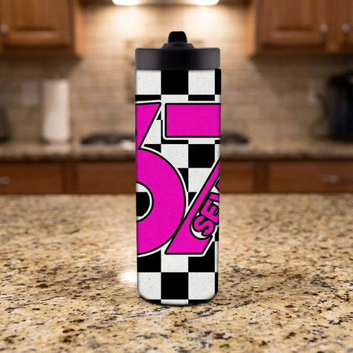 Tumbler with pink and black design on a kitchen counter