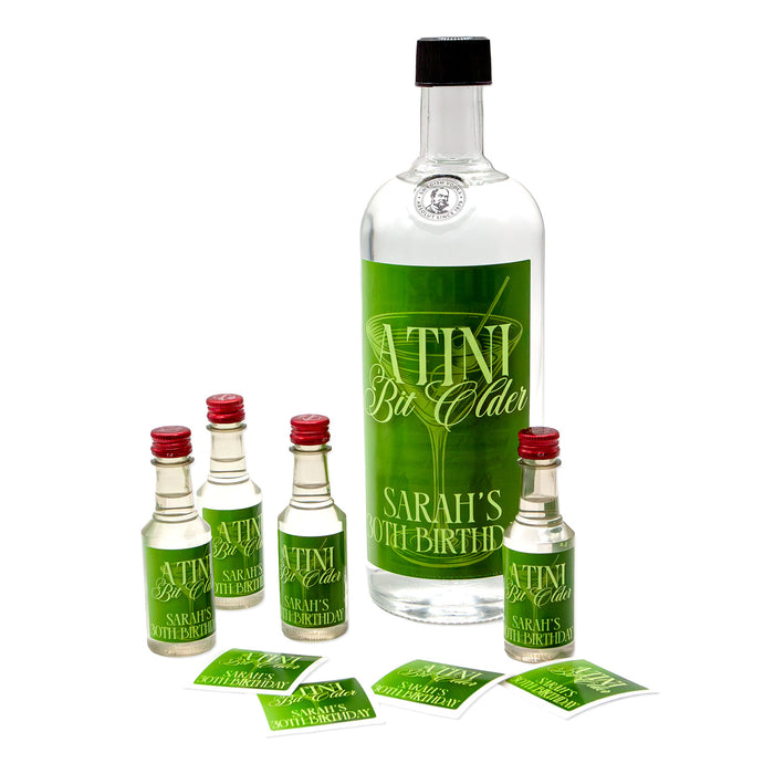 Bottle and mini bottles with green labels on a white background