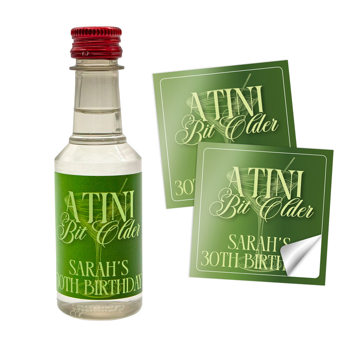 Miniature bottle 'A Tini Bit Older' with personalized labels on a white background
