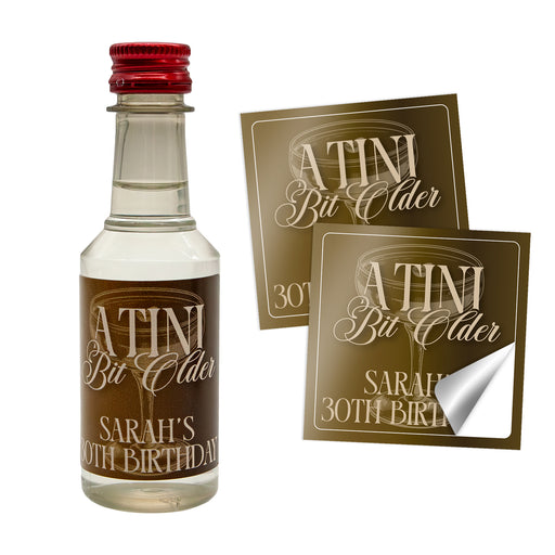 Miniature bottle of alcohol with personalized labels on a white background