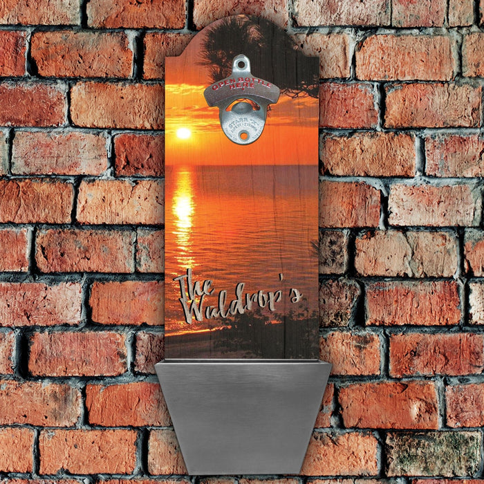 Bottle opener with sunset design and 'The Waldrop's' text on a brick wall background